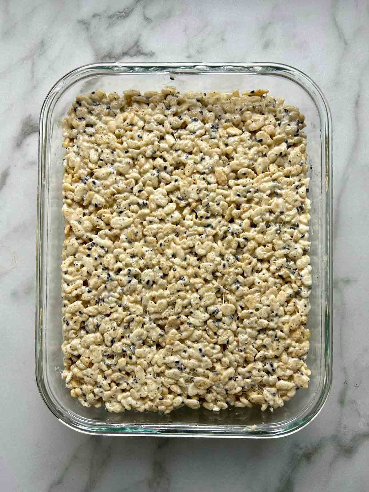 rice cereal mixture packed into rectangular glass container.