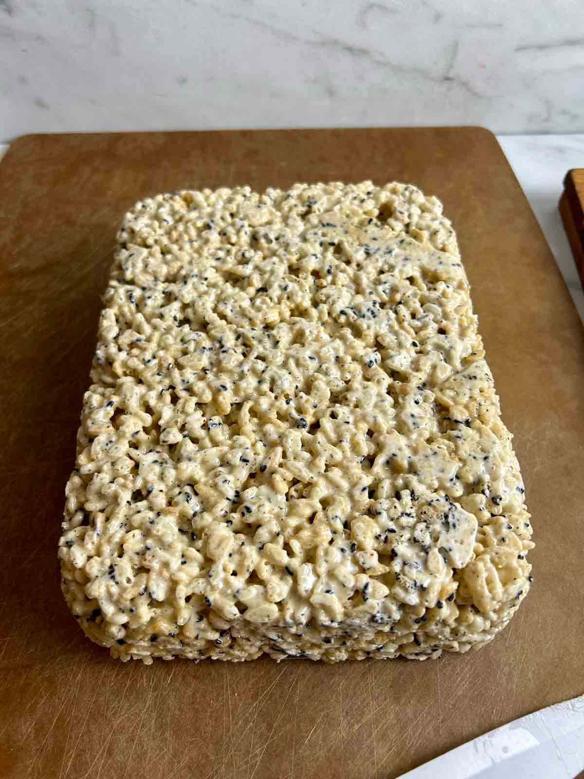 rectangular block of Rice Krispies released onto cutting board.