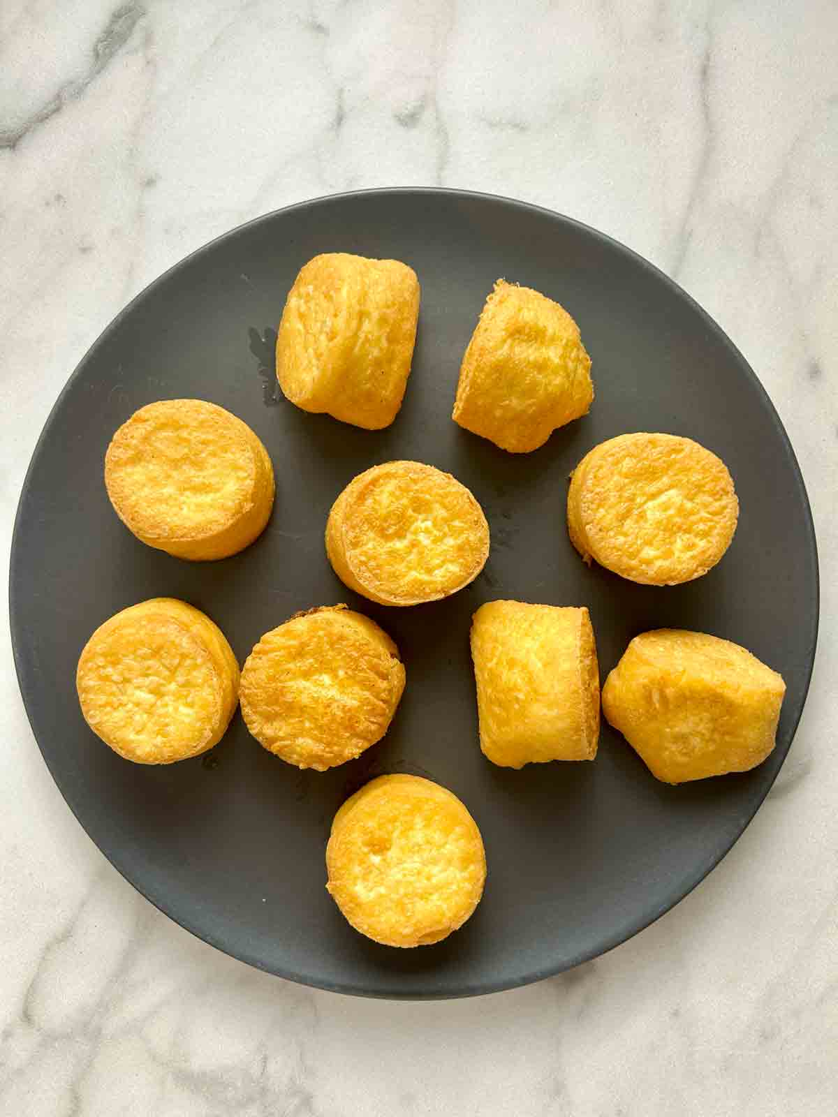 deep fried egg tofu pieces sitting on plate.