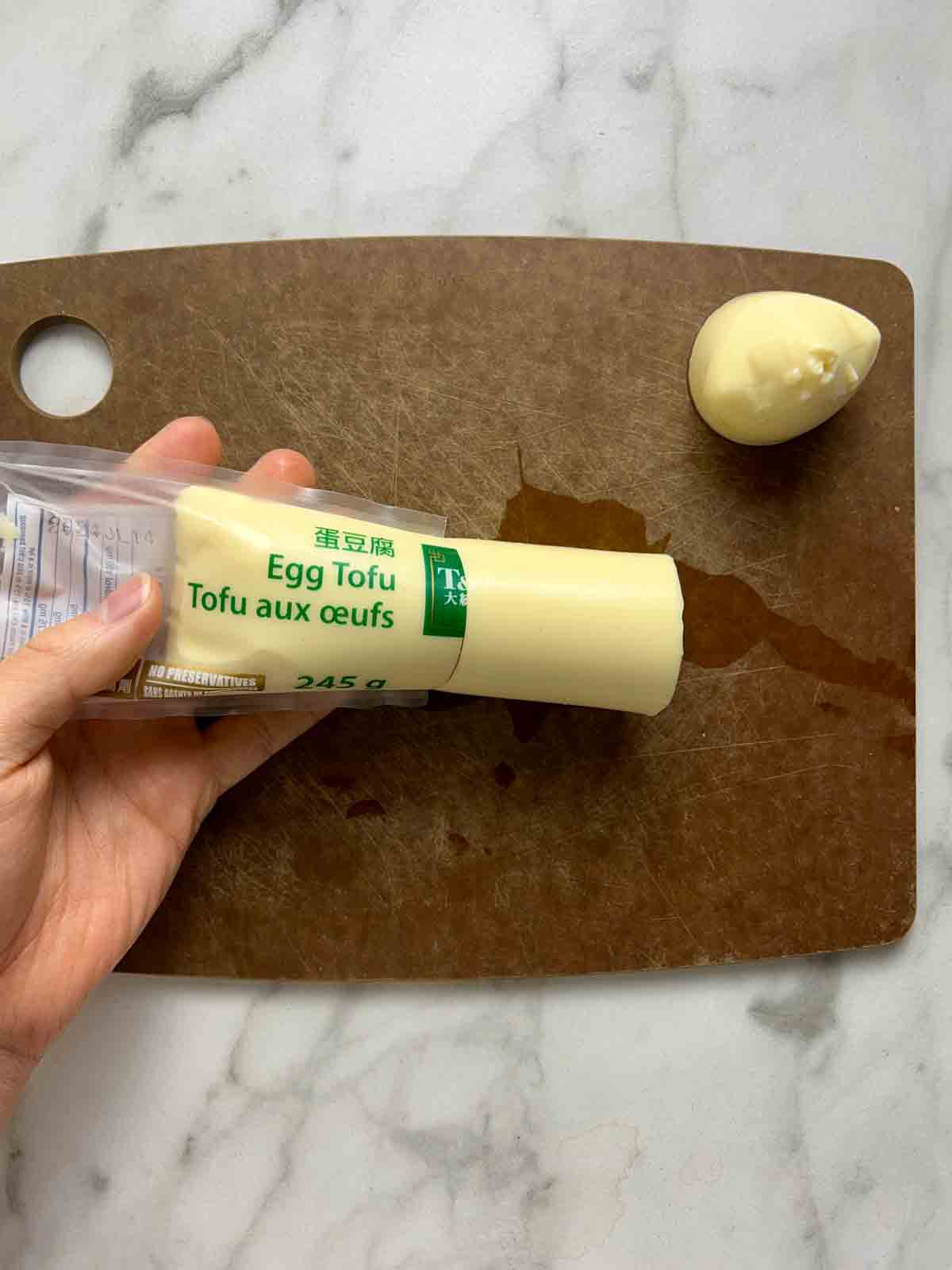 egg tofu being squeeze out of packaging.