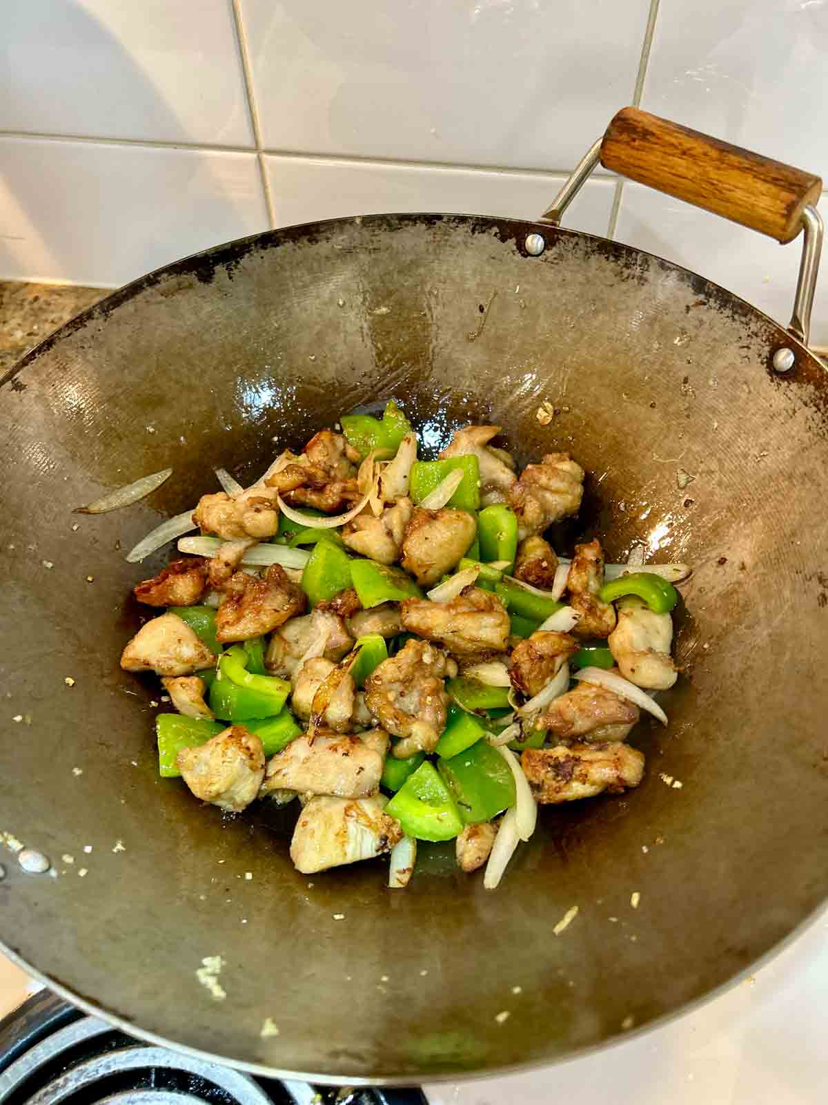 chicken added to wok.