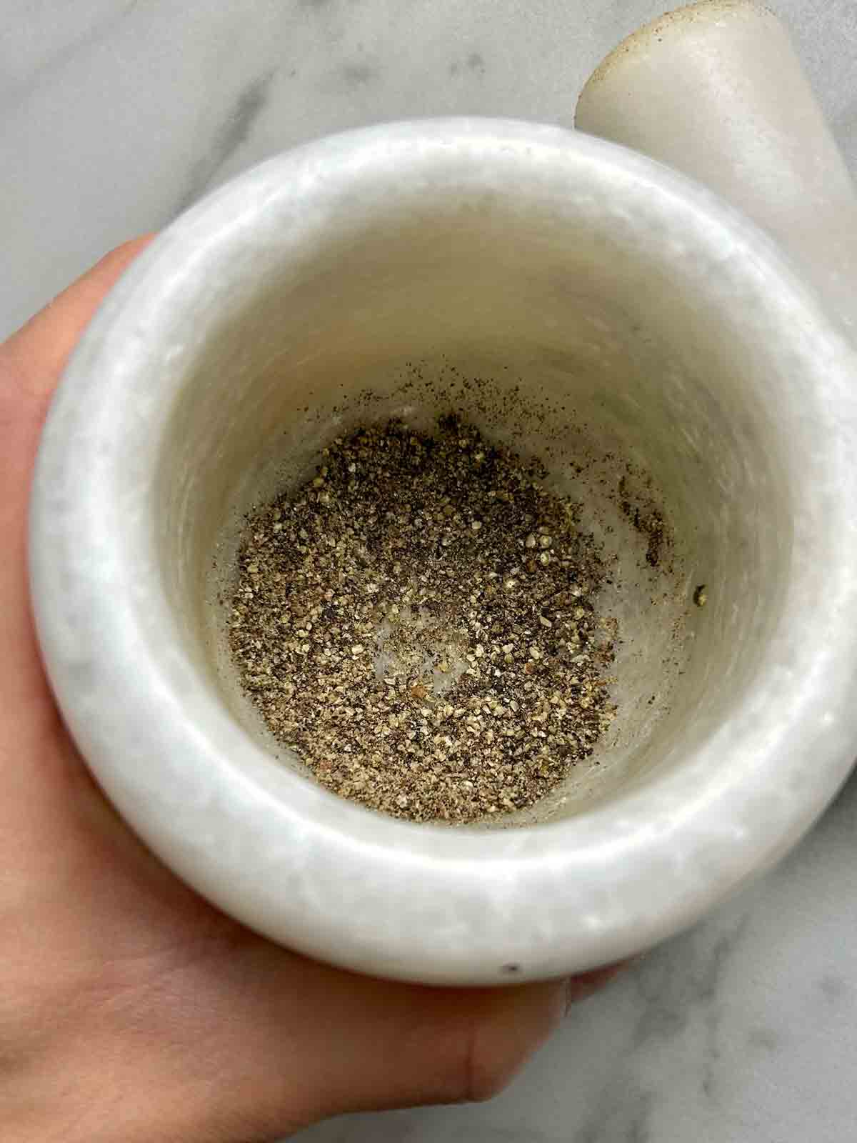 coarsely ground black pepper in a mortar.