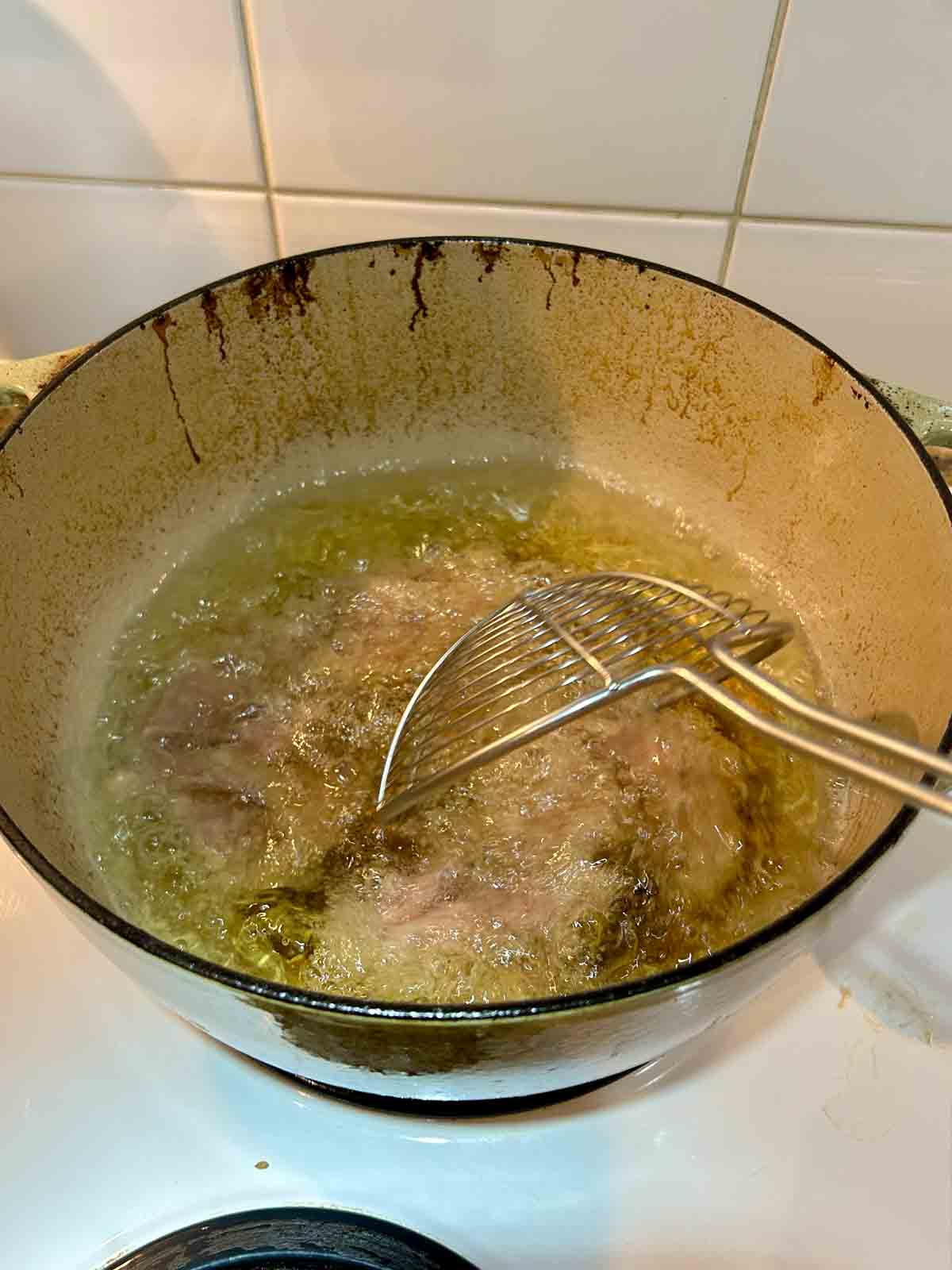 meat being cooked in hot oil.