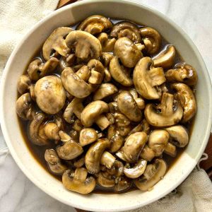 overhead shot of cooked mushrooms on plate.