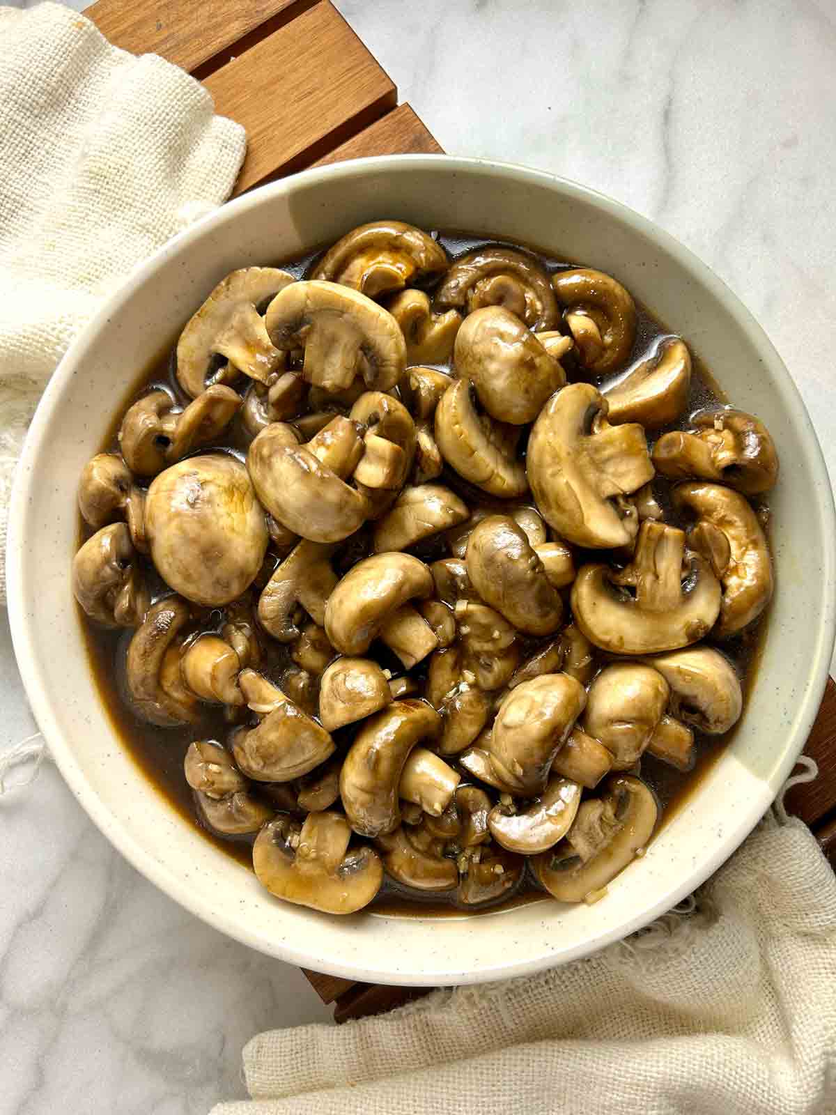 overhead shot of cooked mushrooms on plate.