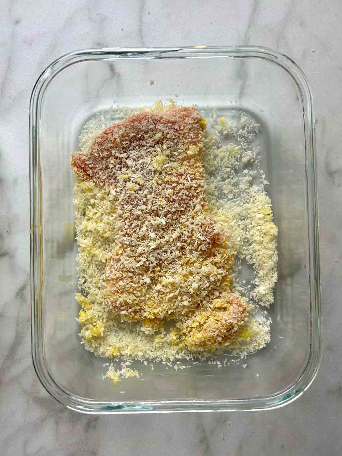 chicken being breaded in panko.