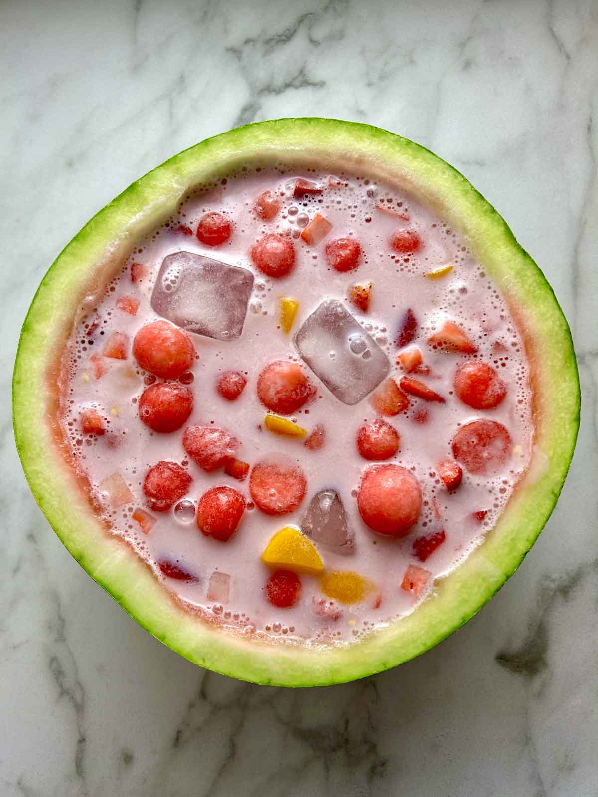 overhead shot of hwachae in watermelon rind.