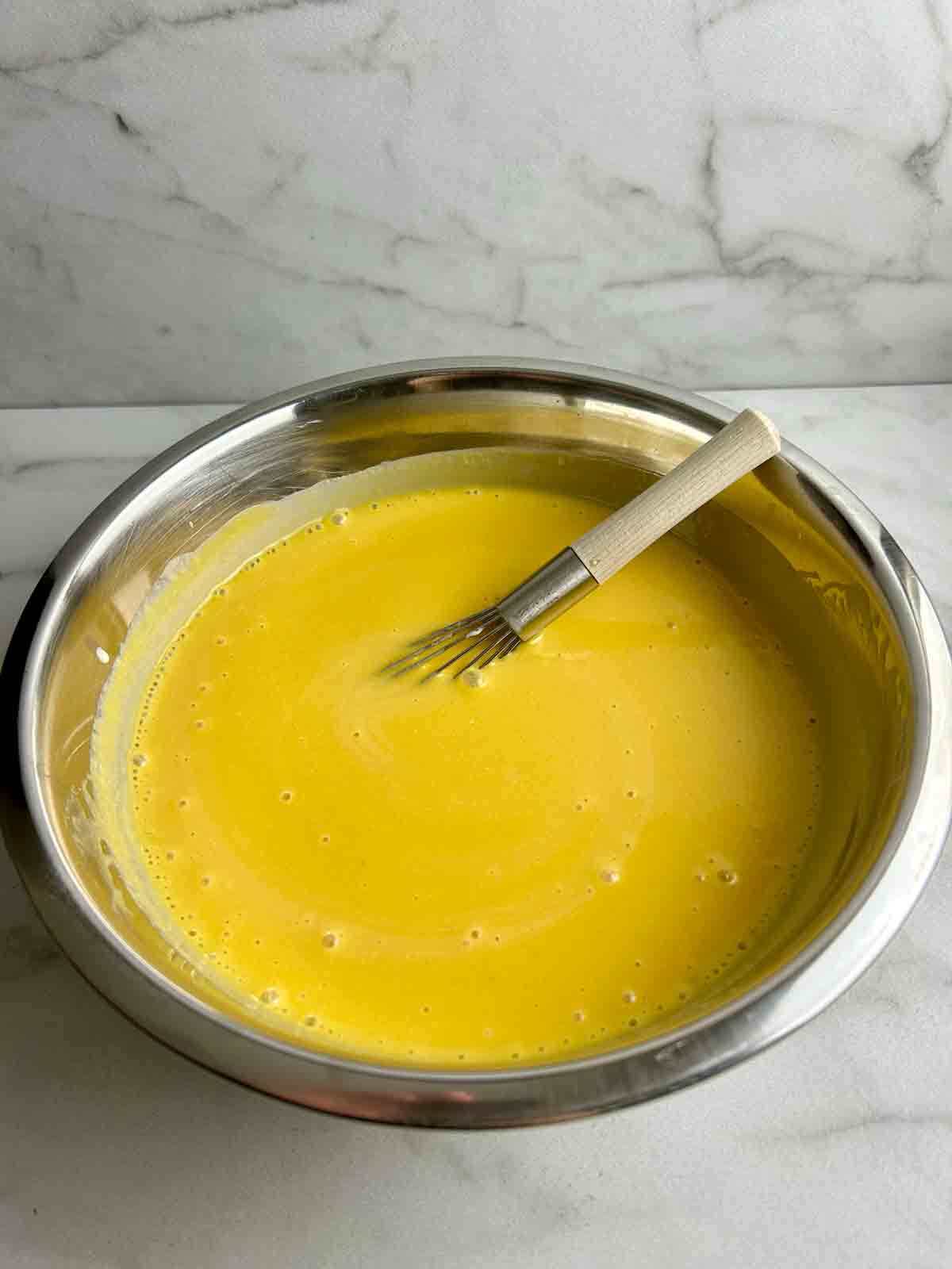 all mango pudding ingredients mixed together in bowl.