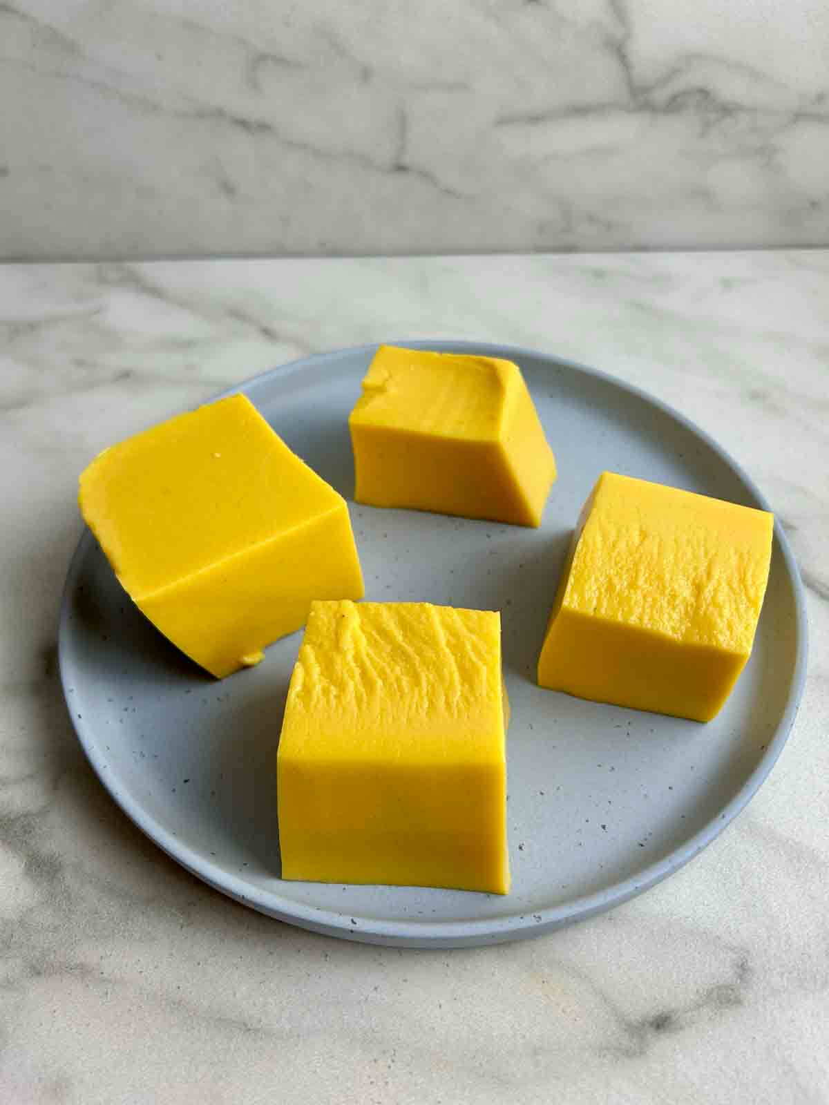 cubes of mango pudding on plate.