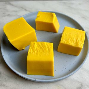 cubes of mango pudding on plate.