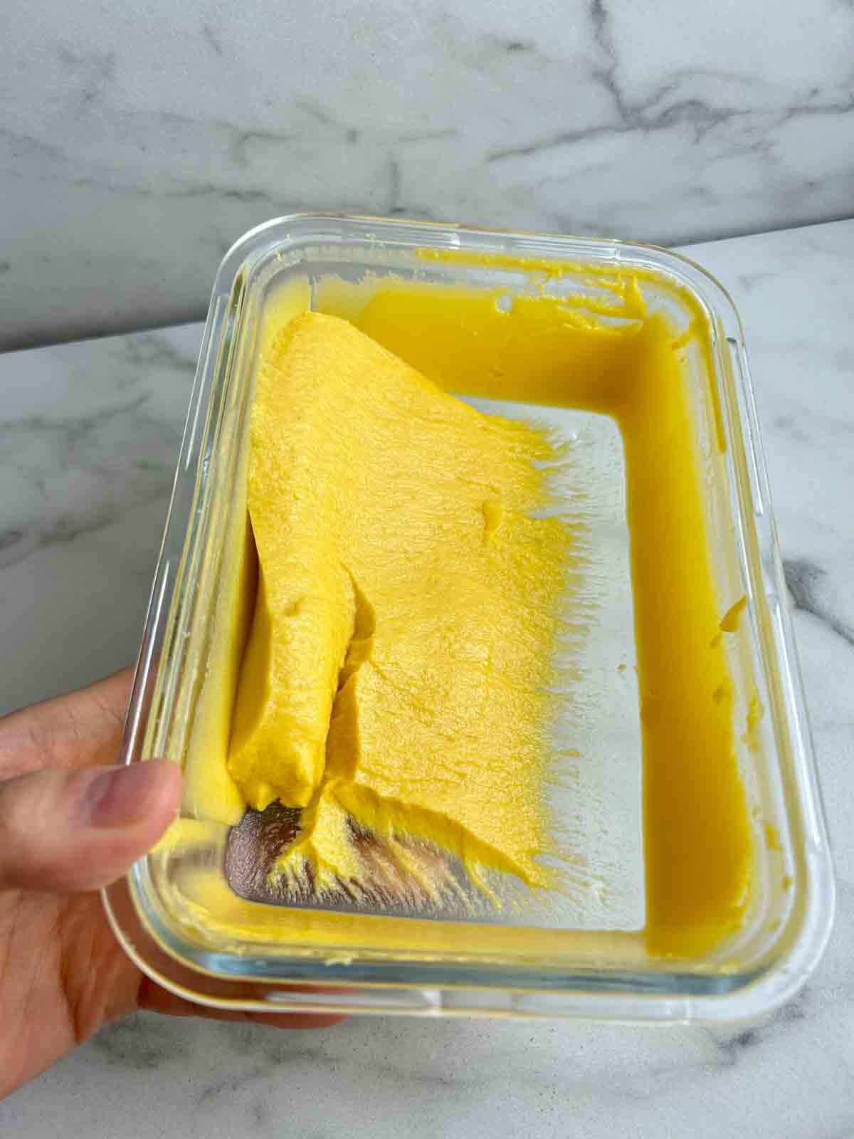 mango pudding stuck to bottom of glass container.