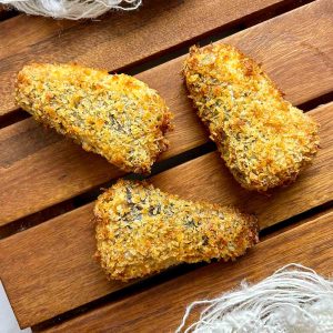 air fried sardines on wooden board.