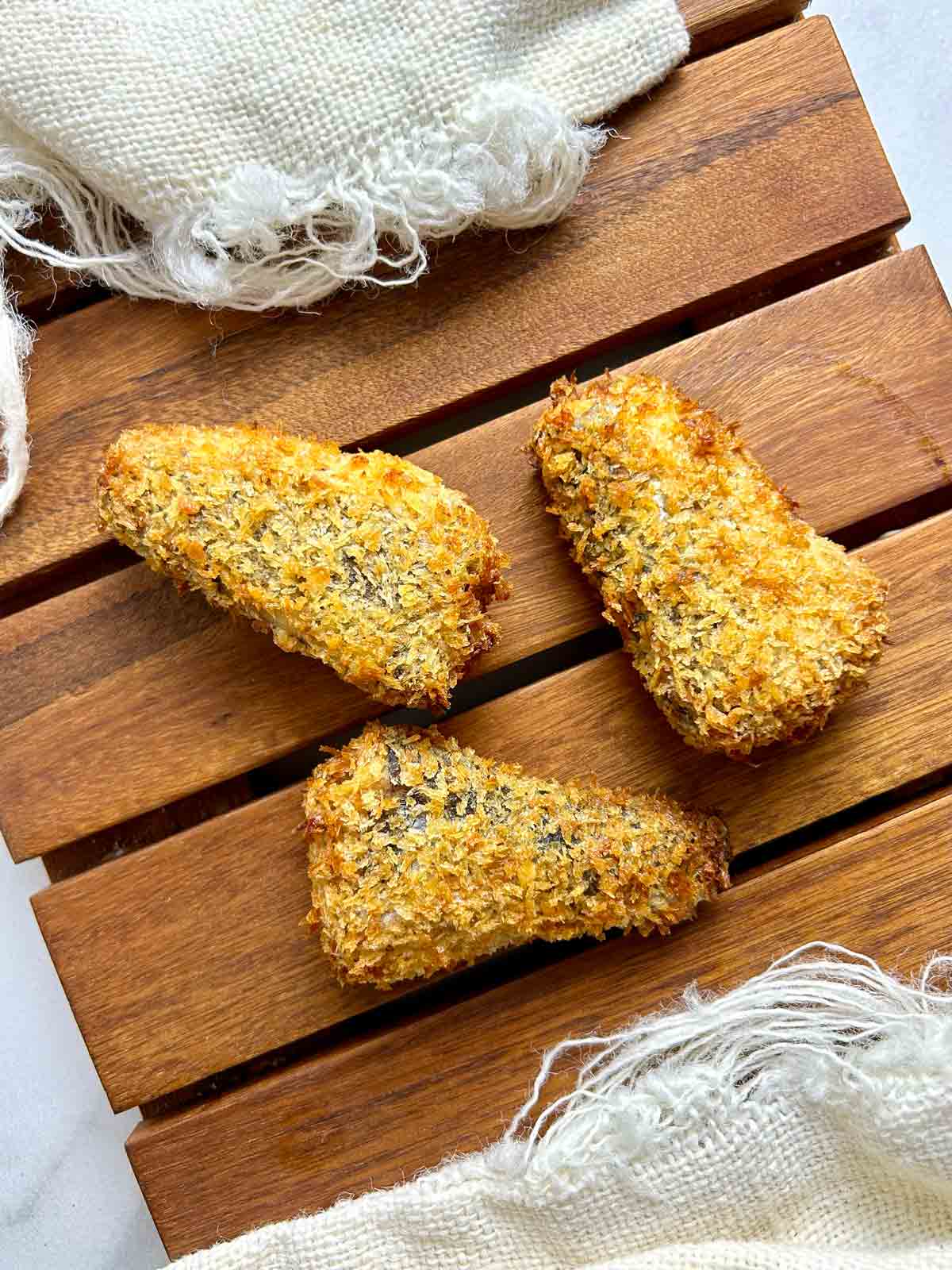 air fried sardines on wooden board.