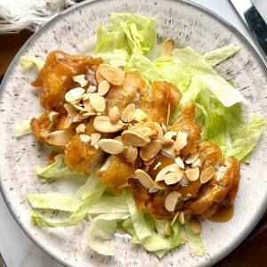 overhead shot of almond boneless chicken on plate.