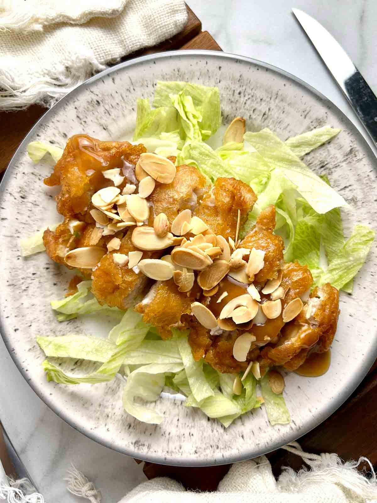 overhead shot of almond boneless chicken on plate.