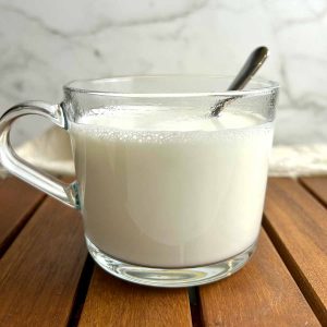 side view of cup of Chinese almond milk.