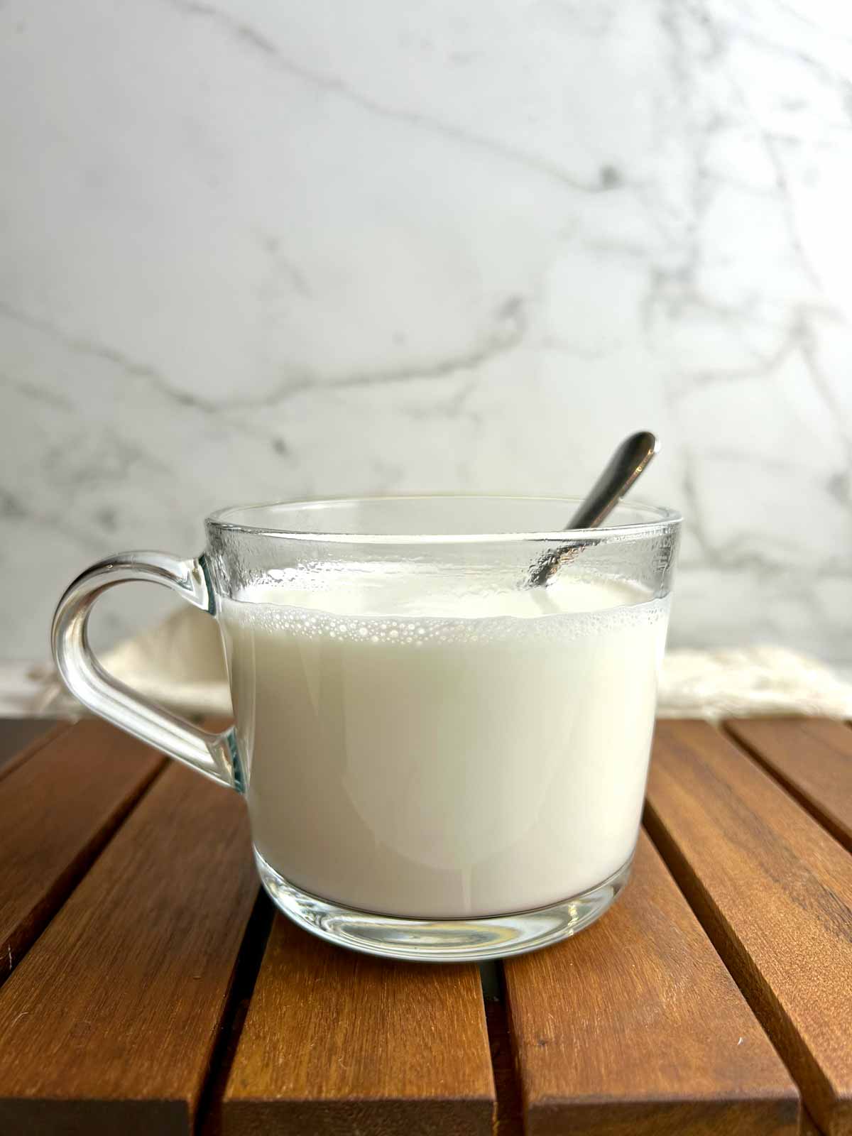 side view of cup of Chinese almond milk.