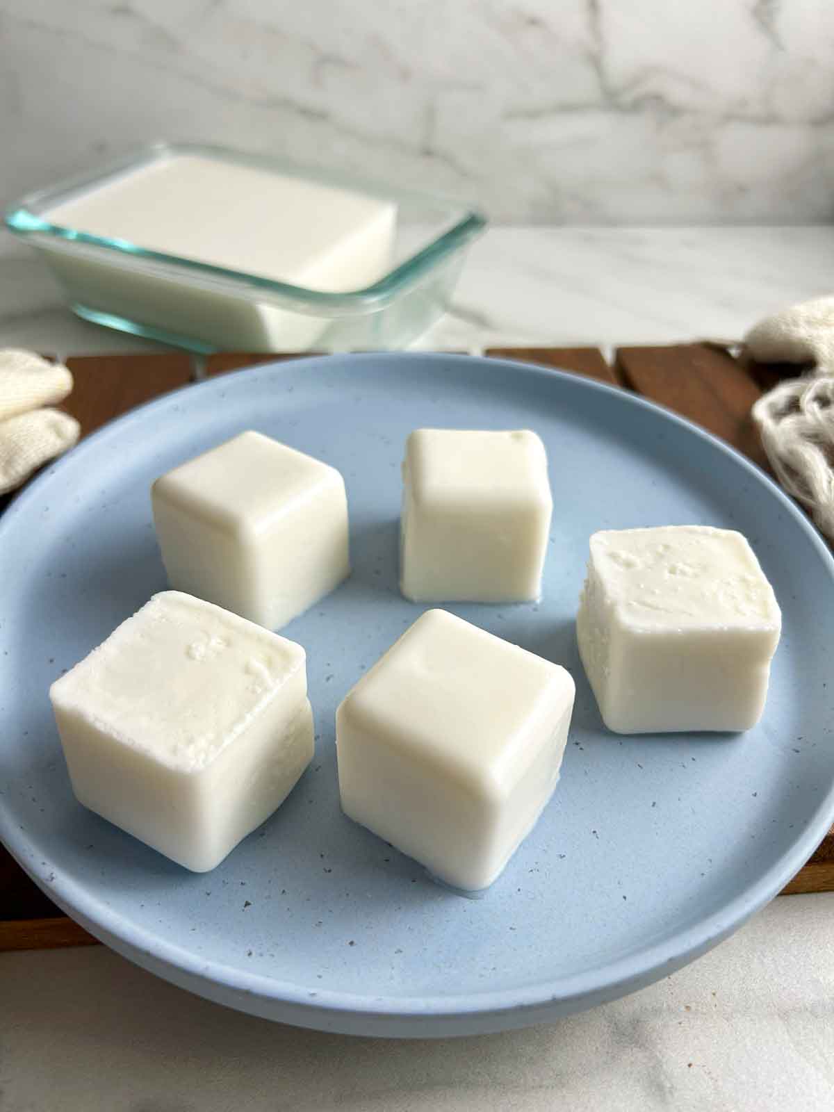 cubes of coconut pudding on plate.