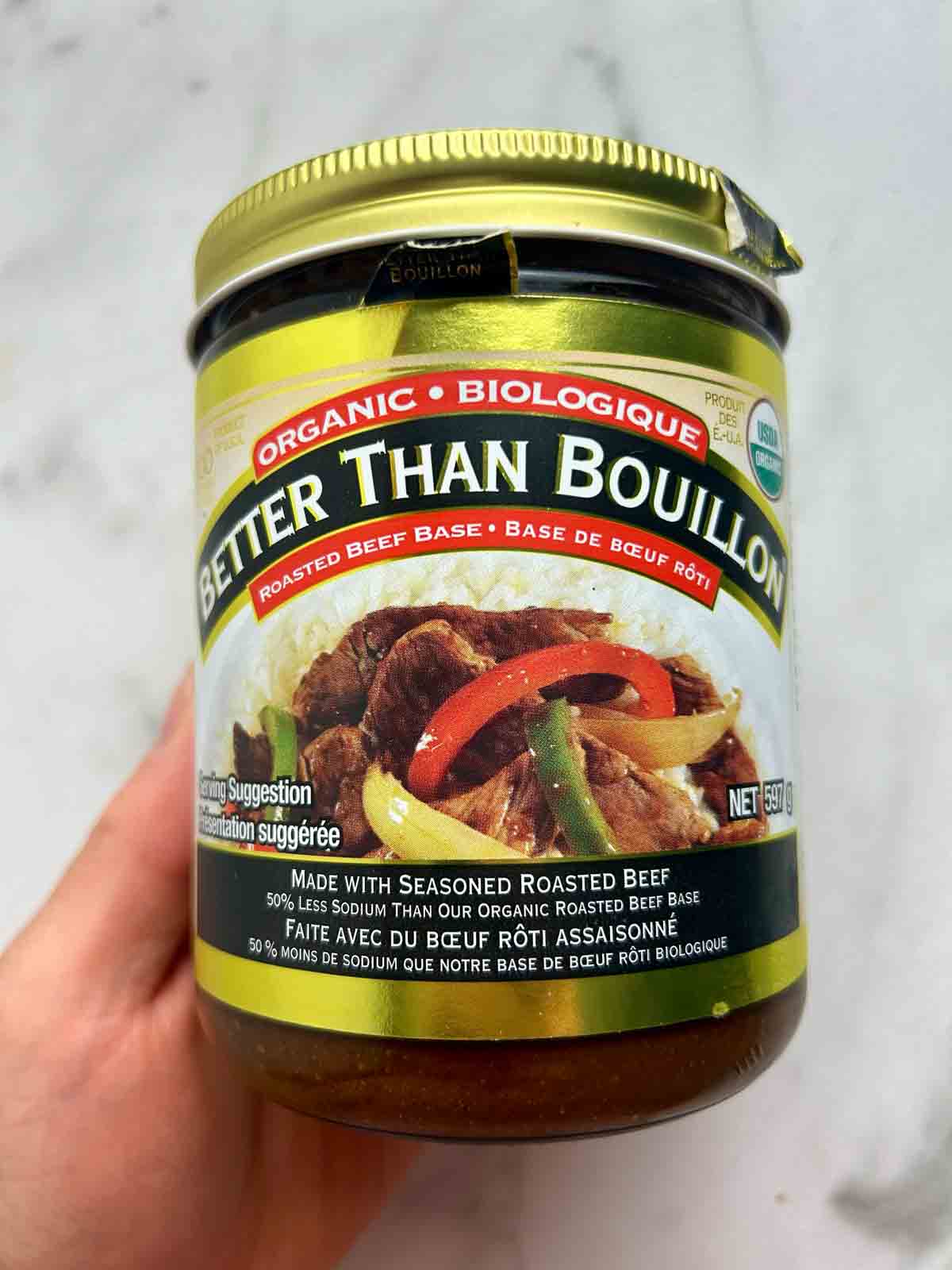 hand holding jar of Better Than Bouillon concentrated beef base.