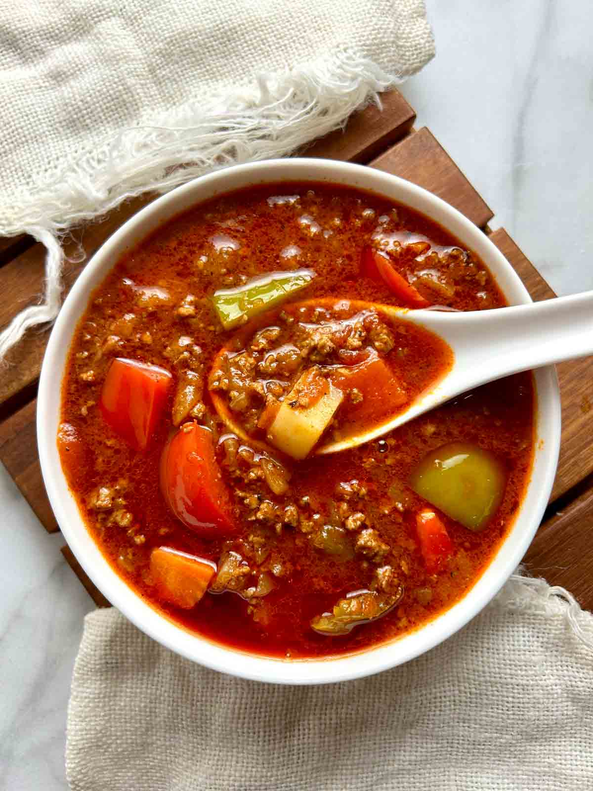 overhead shot of ground beef goulash in bowl.