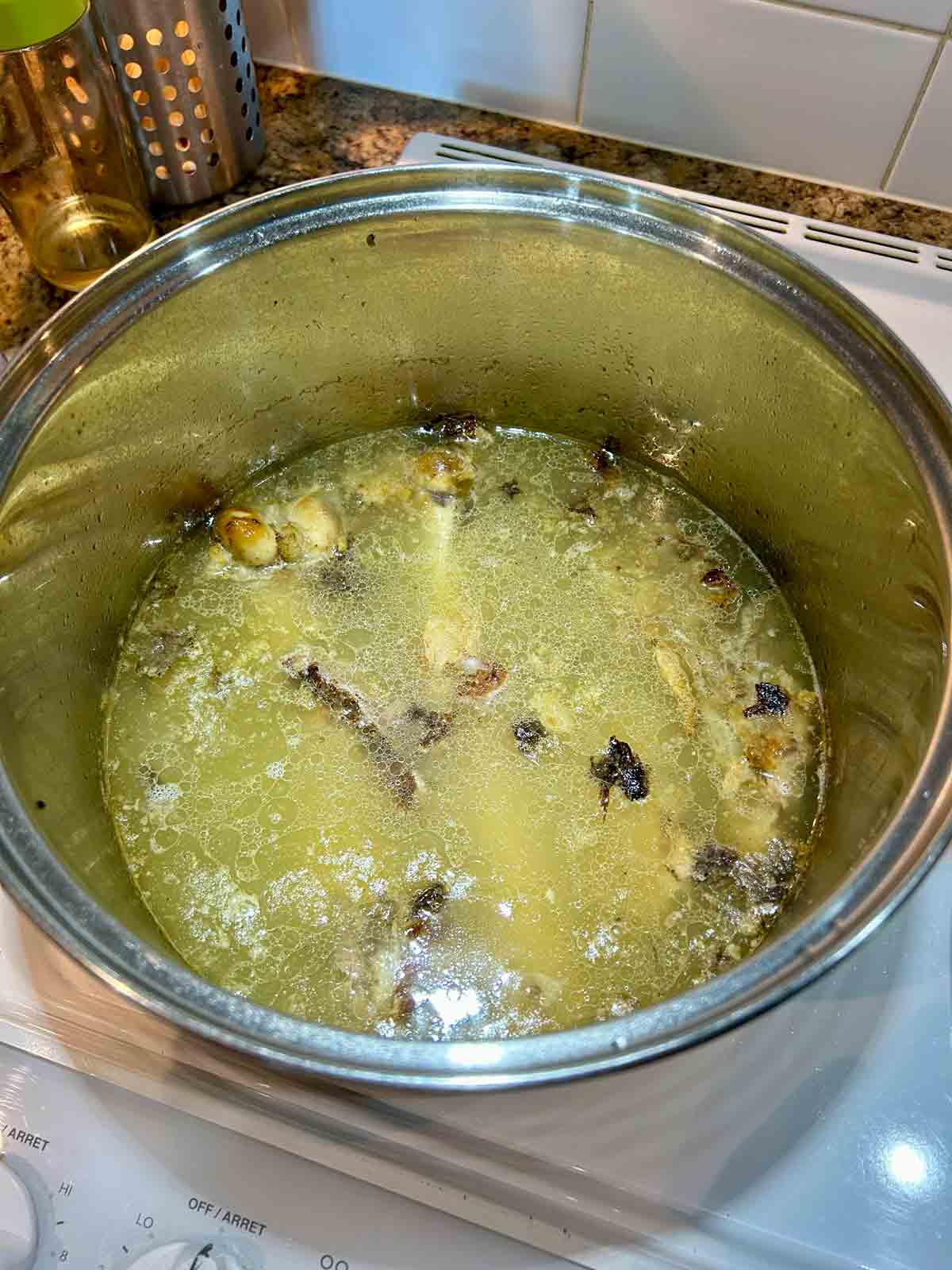 lamb stock being simmered in pot.