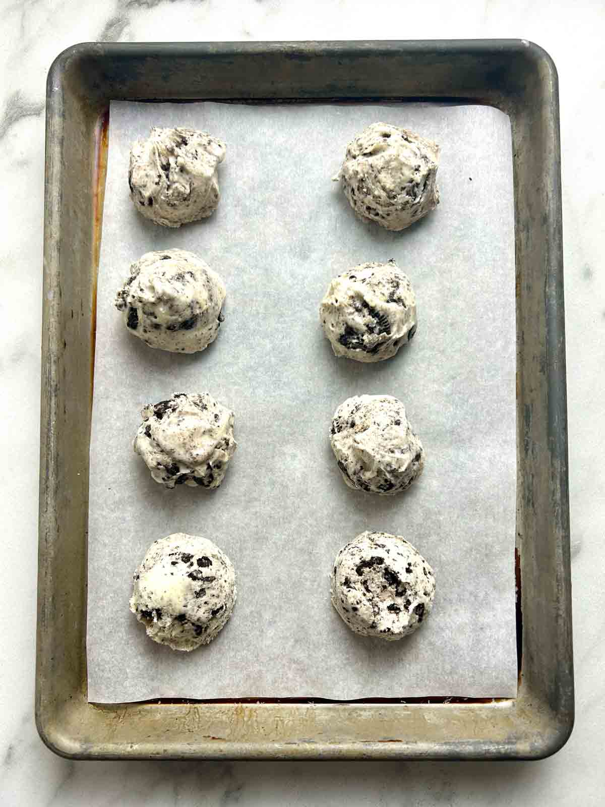 ice cream portioned onto baking sheet.