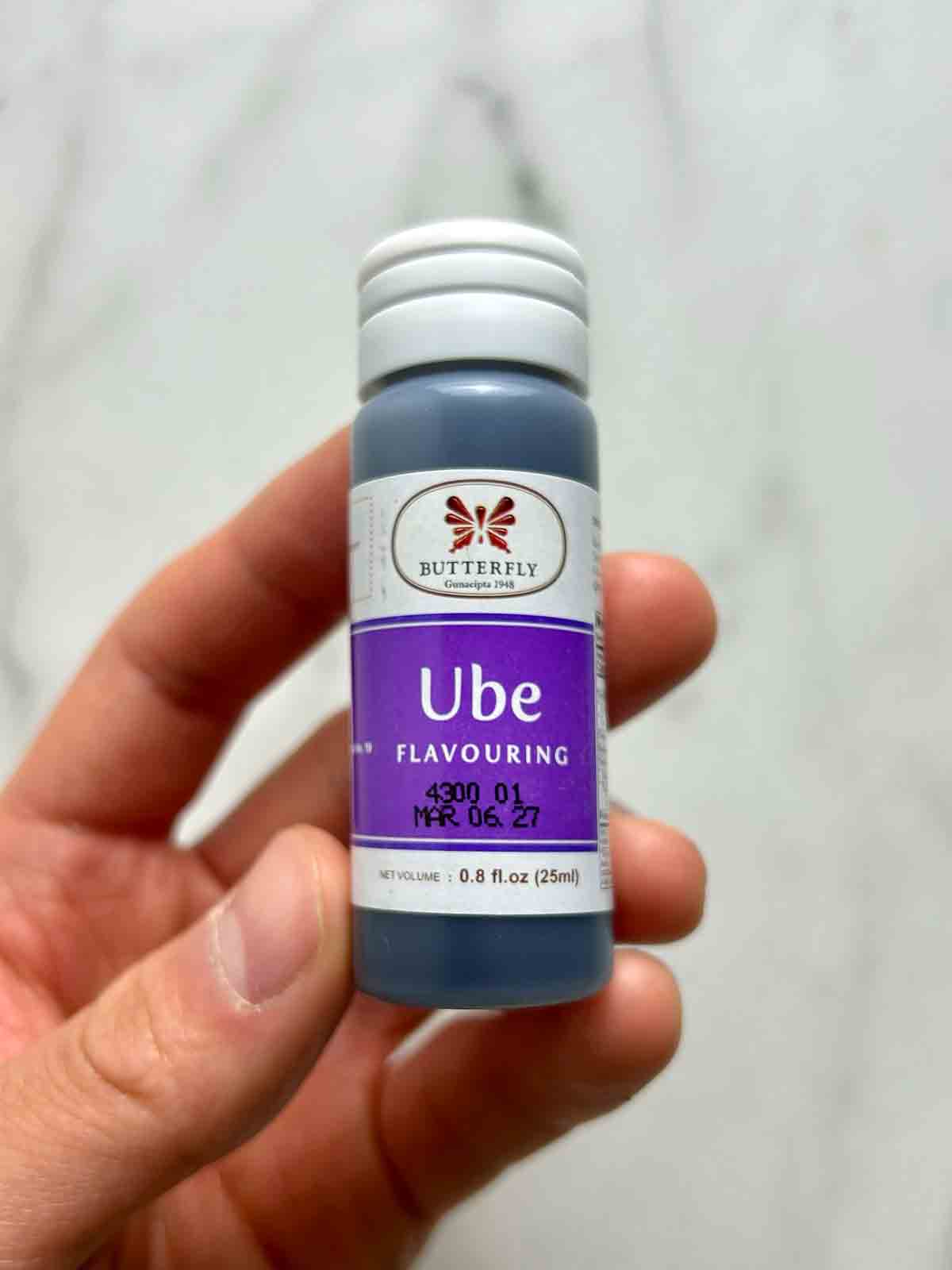 hand holding small bottle of ube extract.