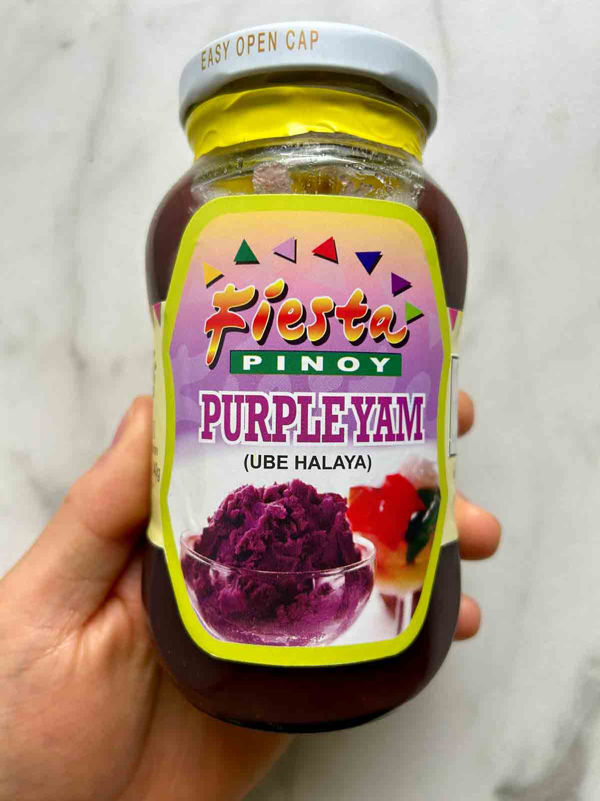 hand holding jar of ube halaya.