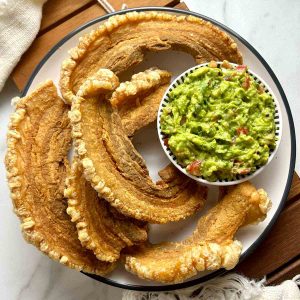 fried chicharrones and bowl of guacamole.