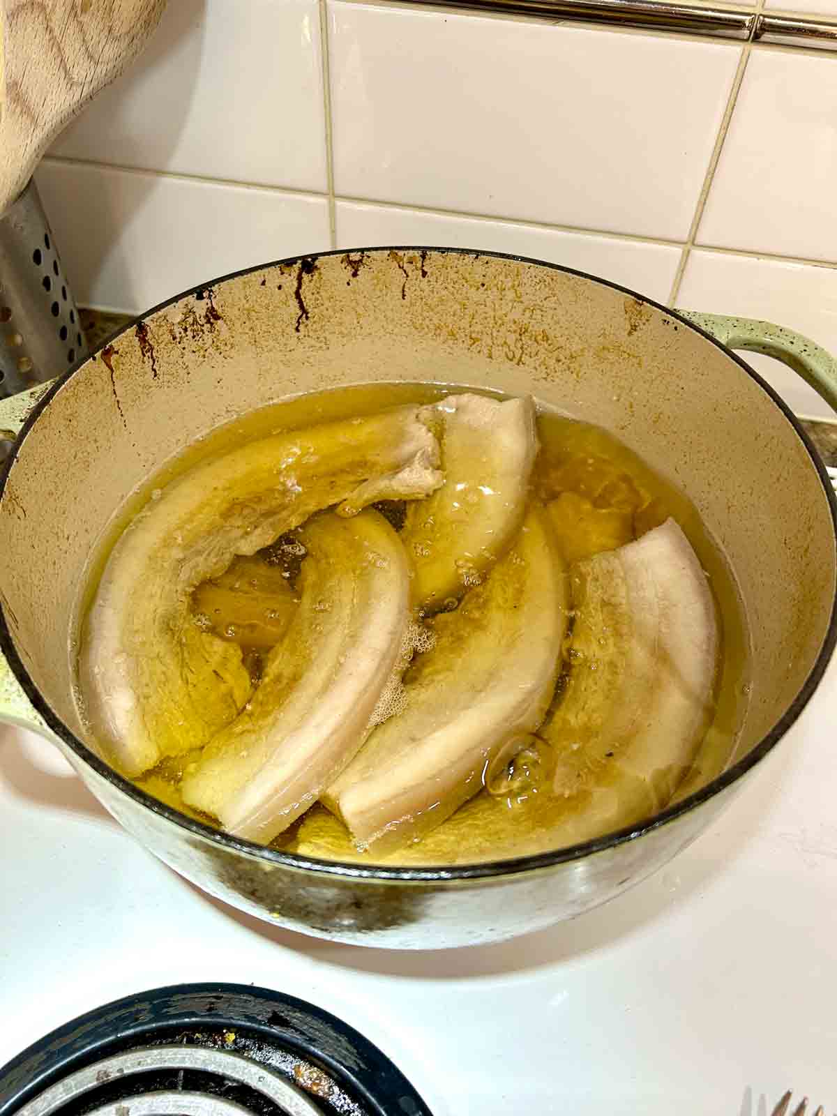 pork belly frying in low temperature oil.