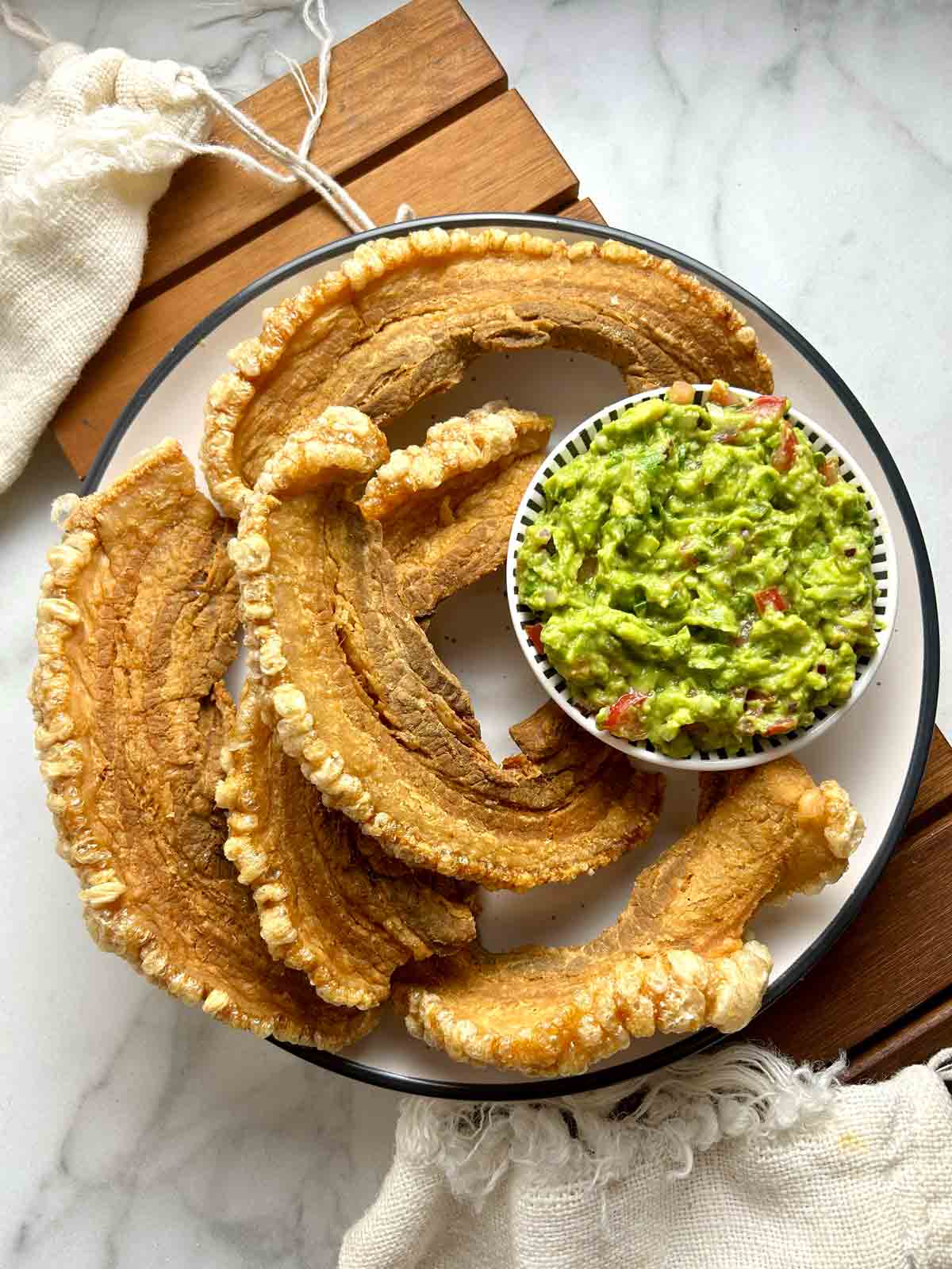 fried chicharrones and bowl of guacamole.