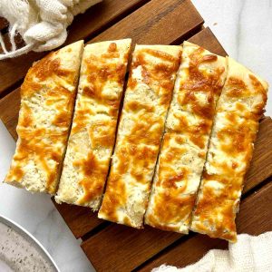 cream cheese breadsticks on wooden board.