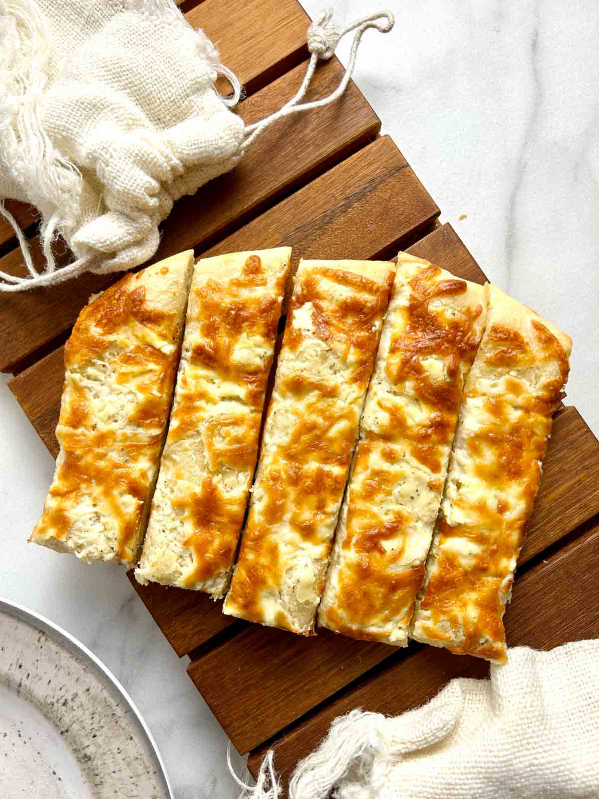 cream cheese breadsticks on wooden board.