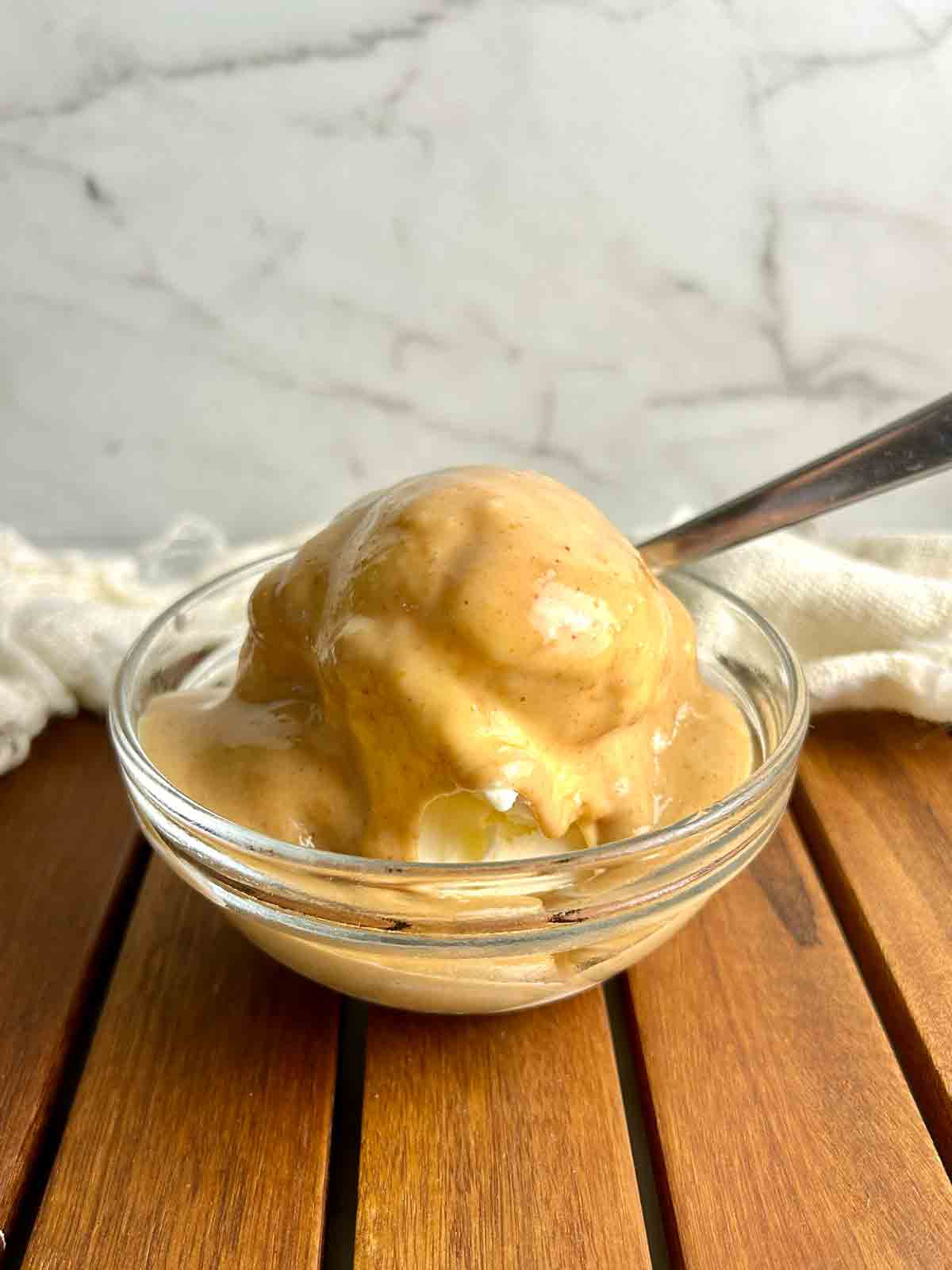 peanut butter sauce drizzled on top of ice cream.