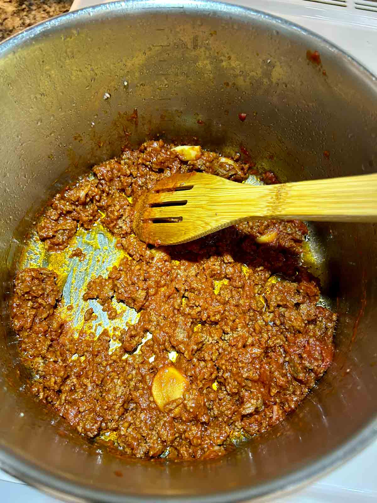 tomato paste being caramelized in oil.