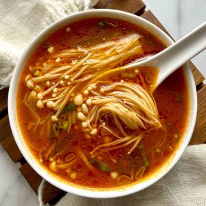 tomato enoki mushroom soup in bowl.