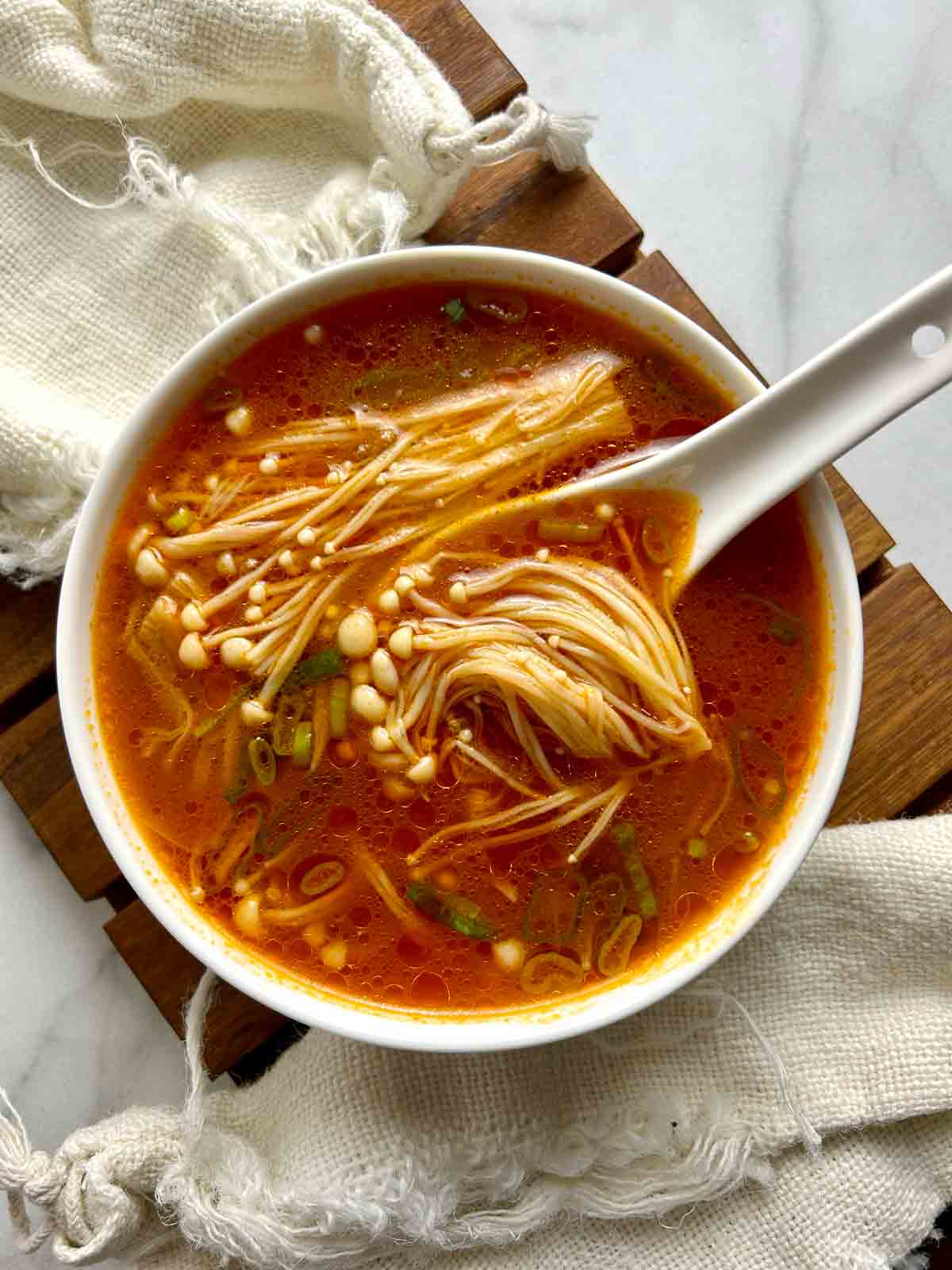 tomato enoki mushroom soup in bowl.