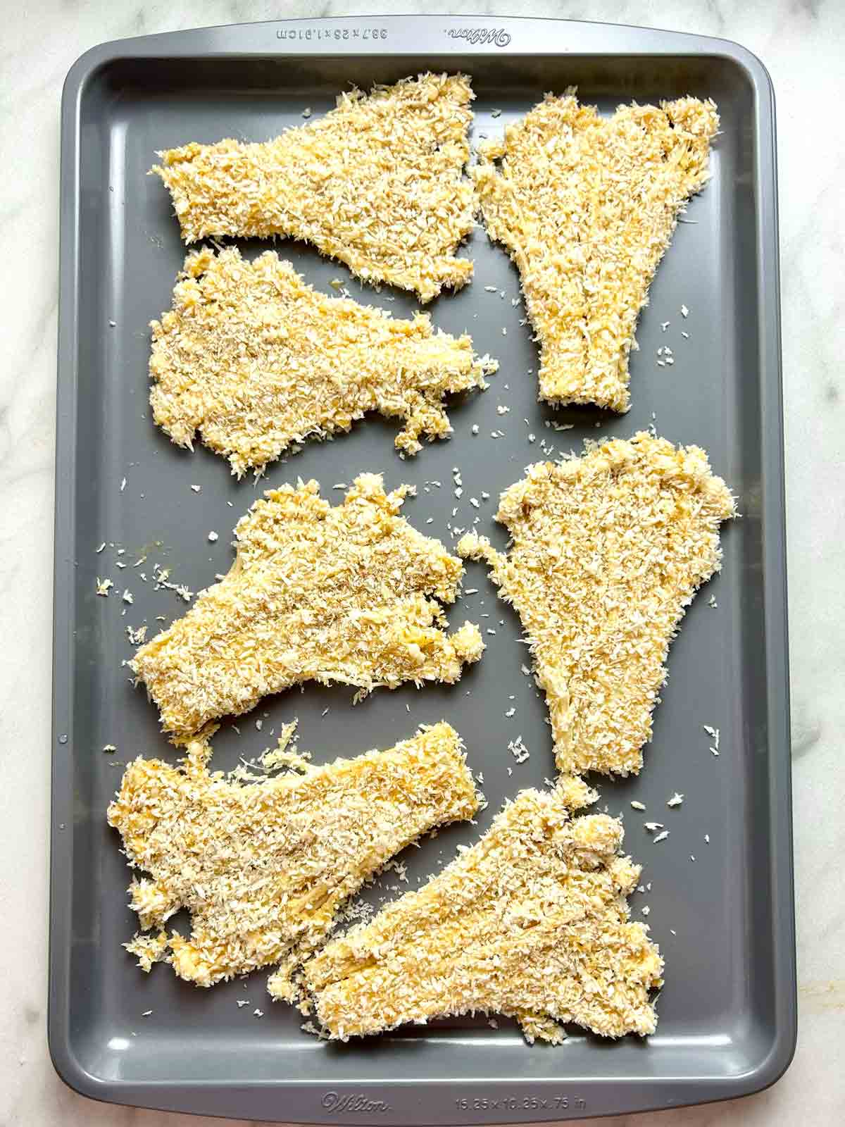 breaded enoki mushrooms on baking sheet.