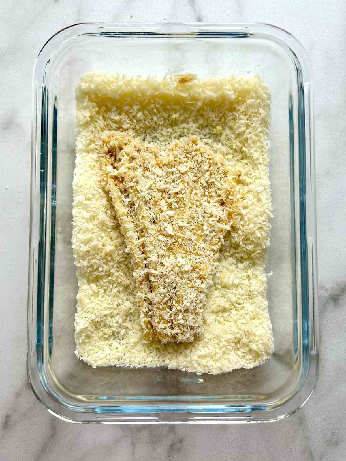 enoki mushroom being coated in breadcrumbs.