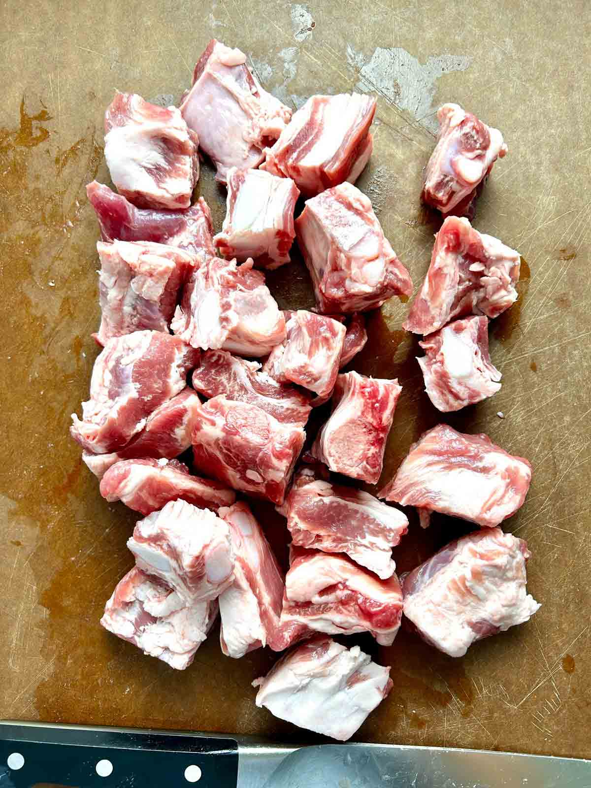 spare ribs cut into small pieces on cutting board.