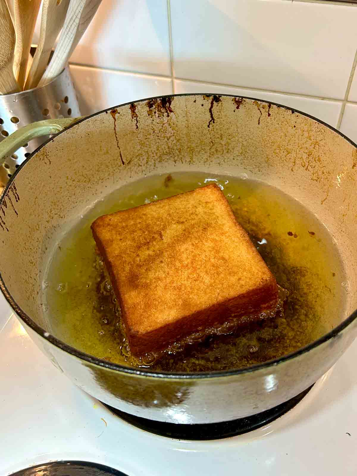 Hong Kong french toast being deep-fried in hot oil.