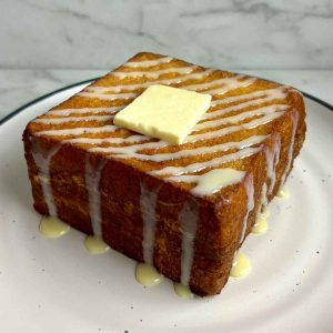 plate of Hong Kong French toast drizzled with condensed milk and a slab of butter,