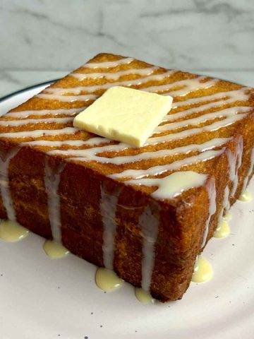 plate of Hong Kong French toast drizzled with condensed milk and a slab of butter,