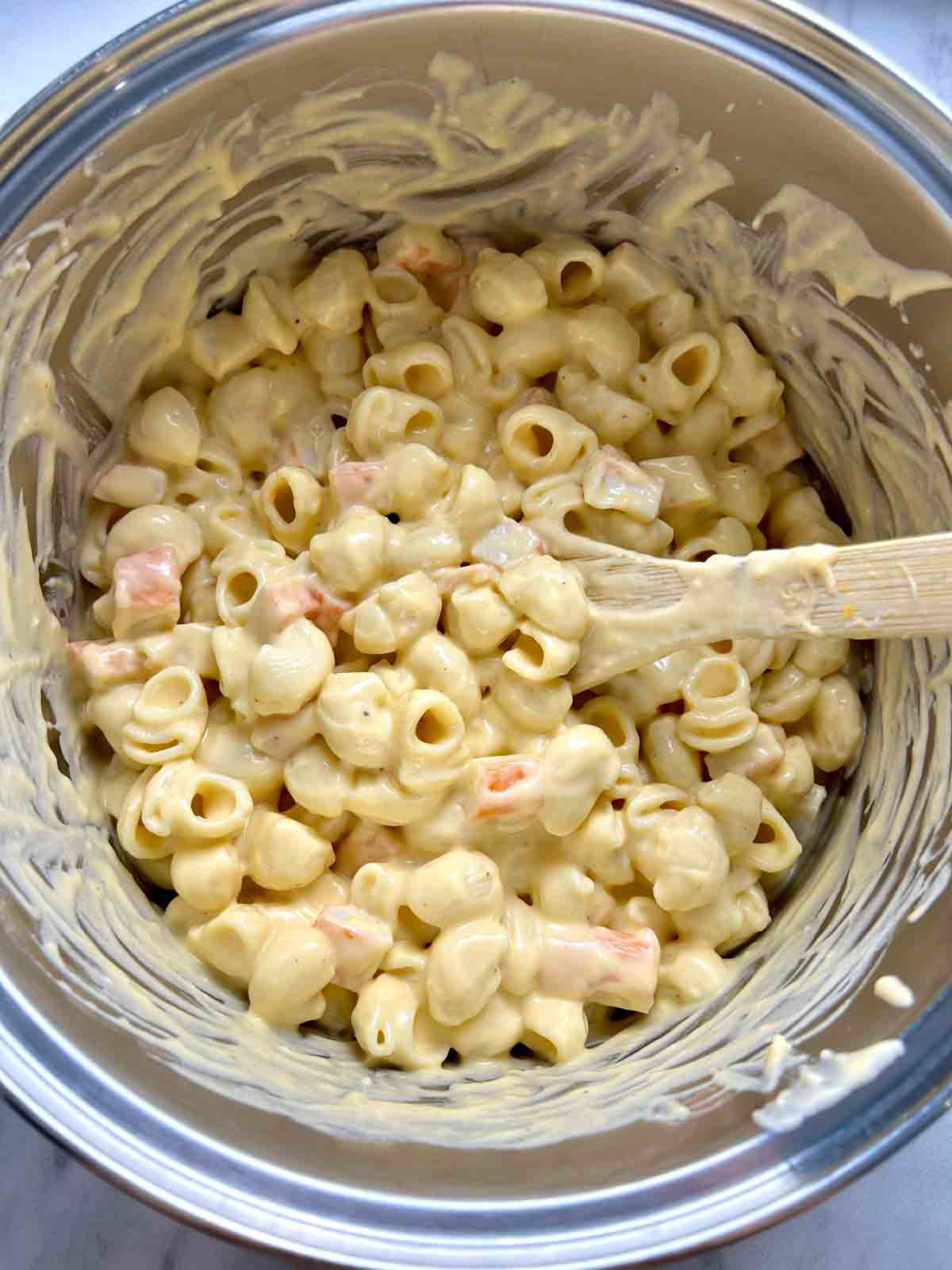 macaroni after being mixed with cheese sauce and imitation crab.