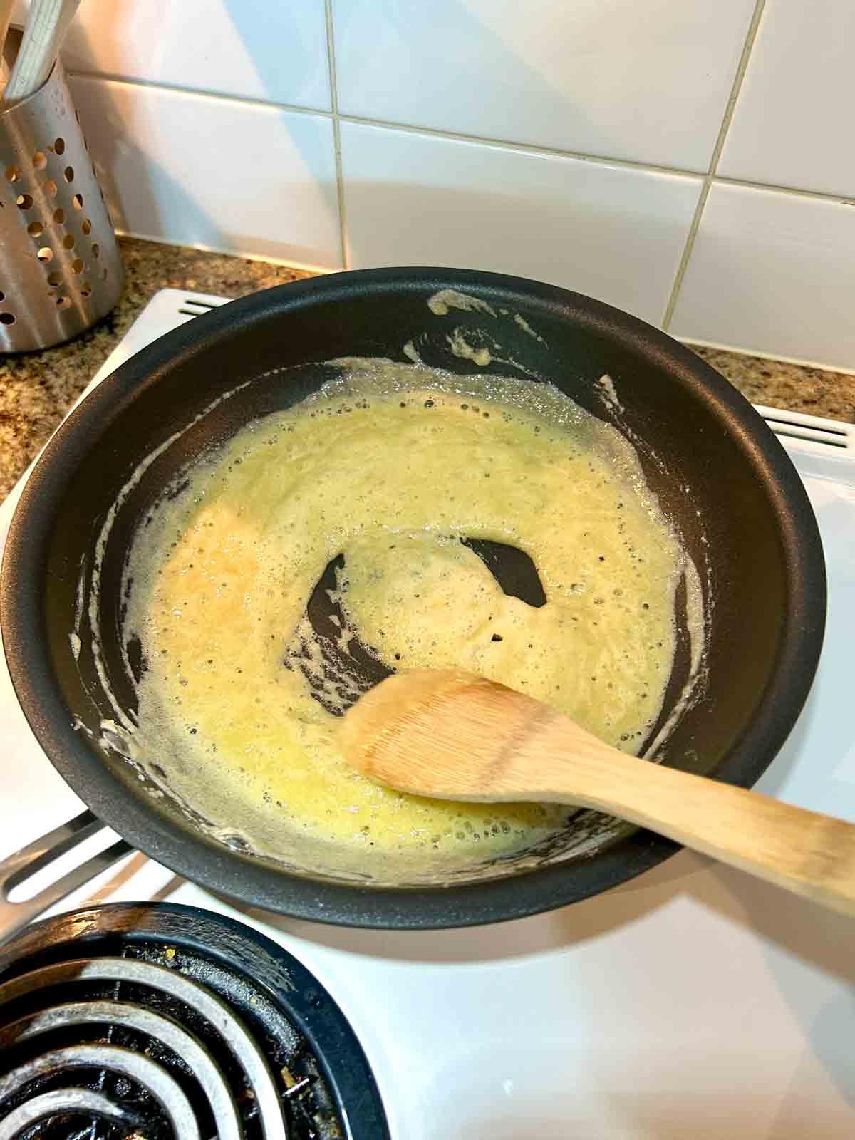 butter and flour being cooked in nonstick pan.