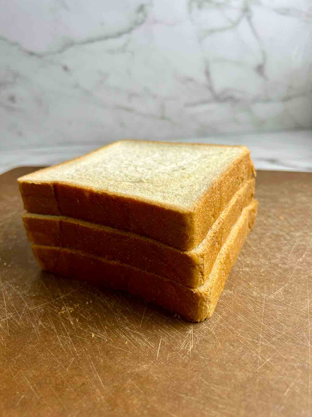 three pieces of milk bread stacked on top of each other.