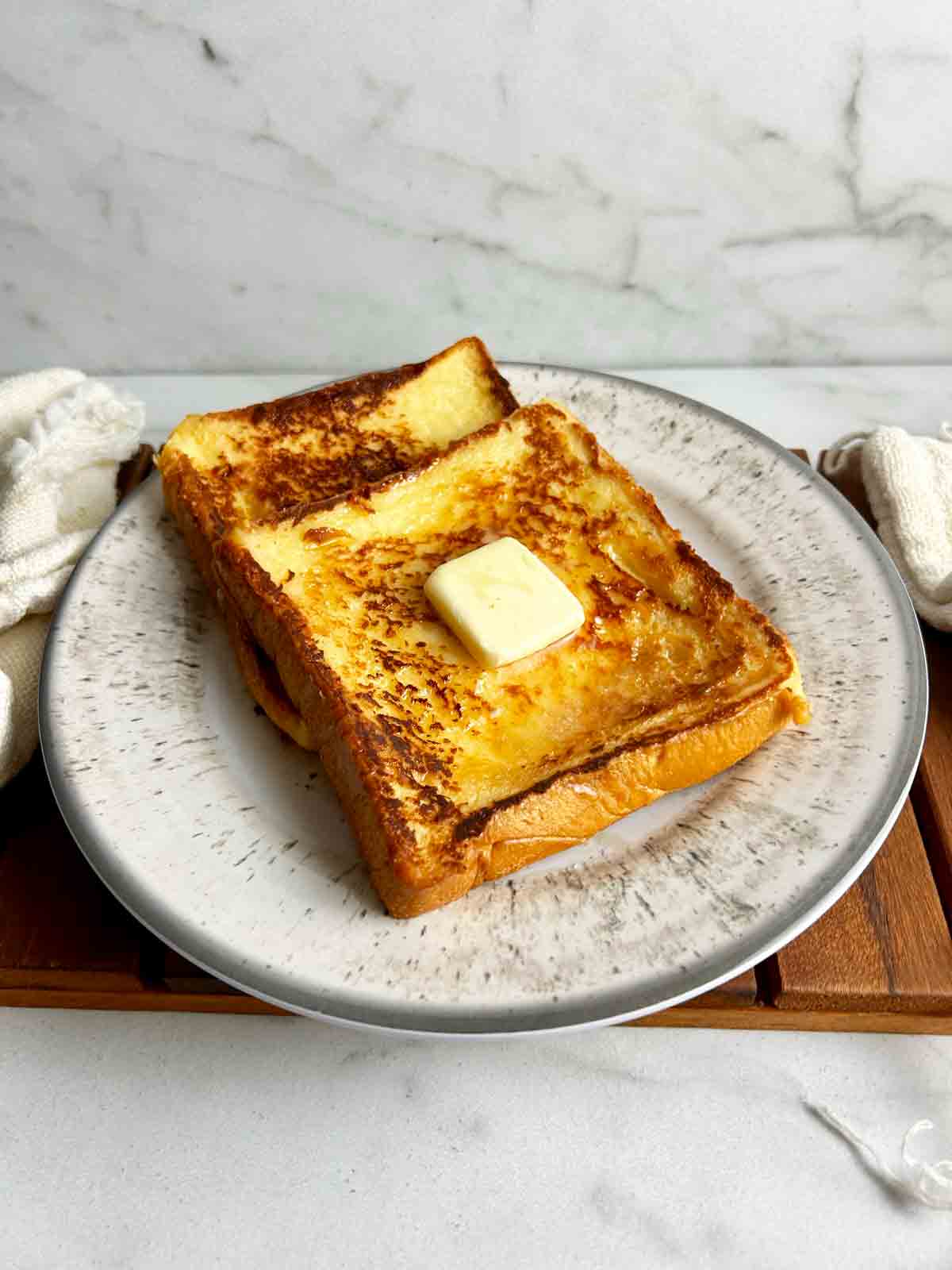 two pieces of milk toast on plate.