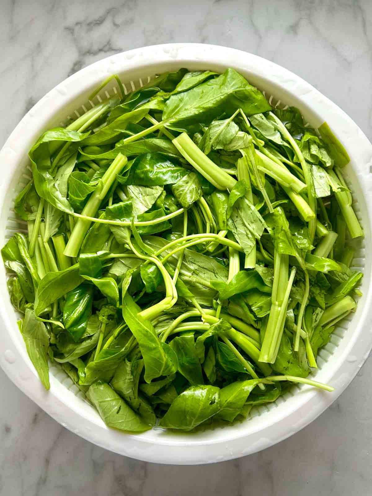 ong choy being soaked in cold water.