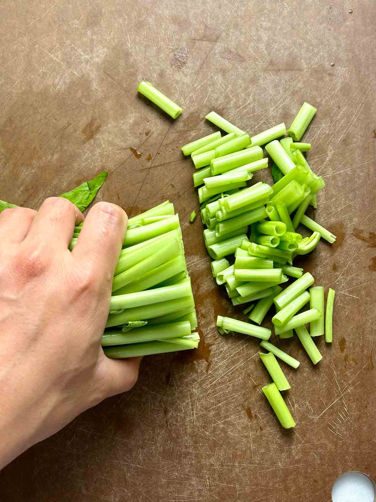 cutting off stems of vegetable.