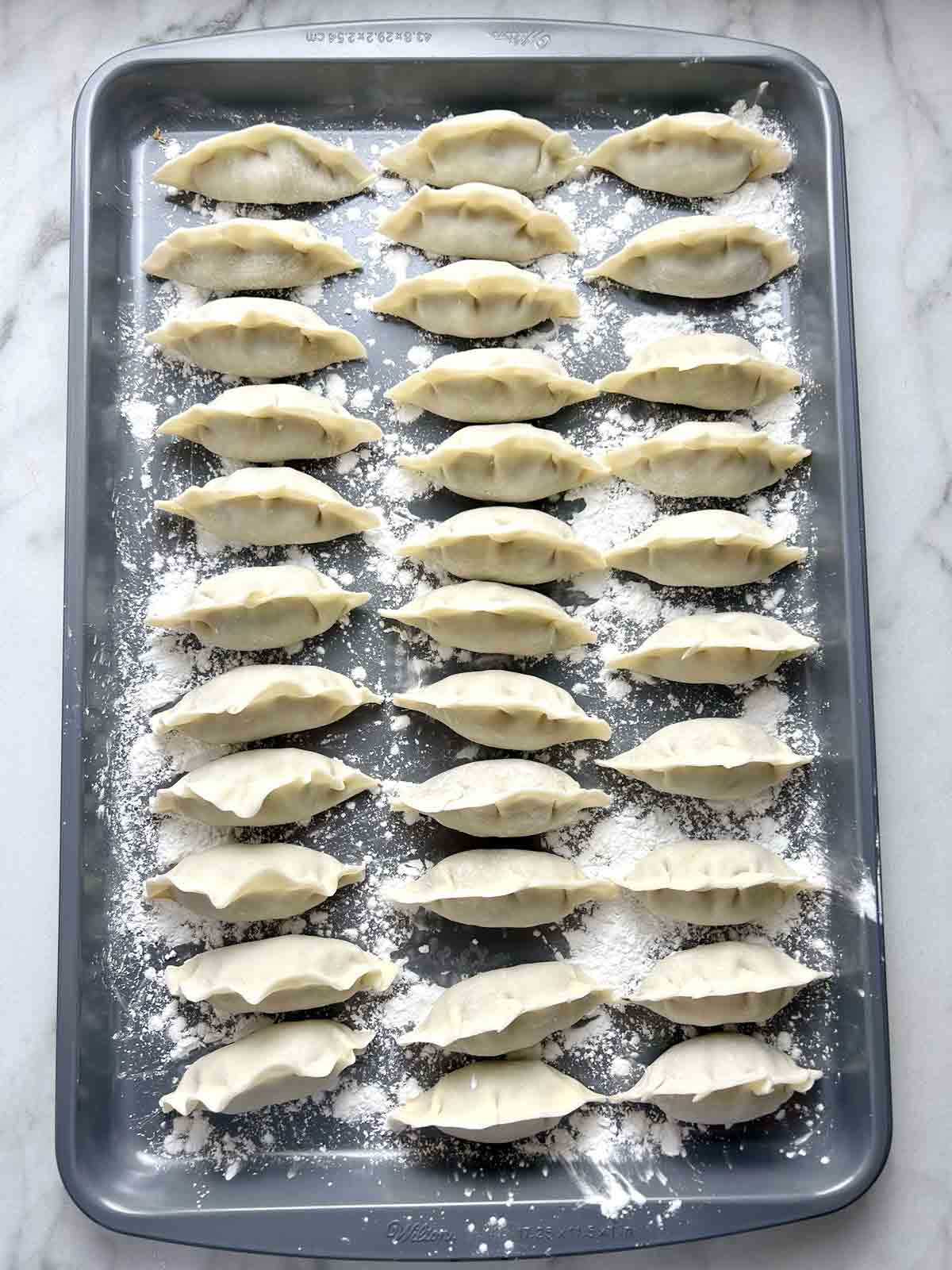 dumplings on baking sheet.